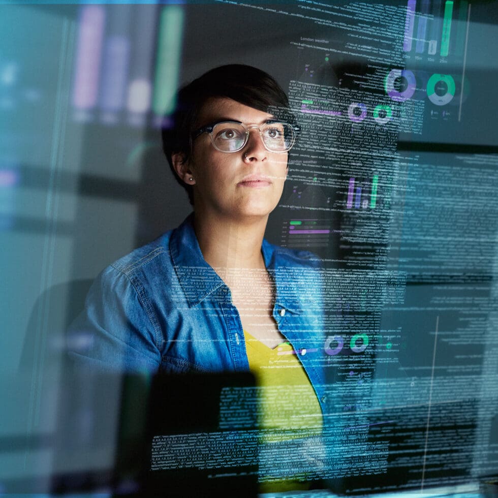 Female IT analyst with glasses reviewing cloud server misconfigurations